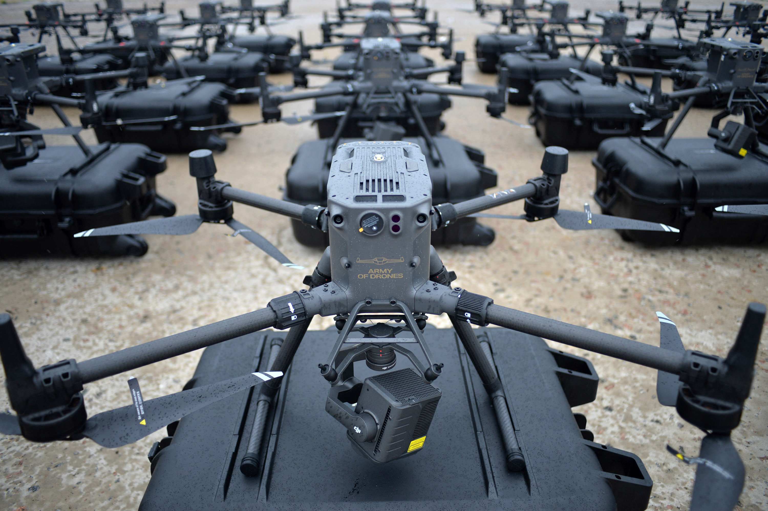 grid of DJI drones on top of cases on an airstrip
