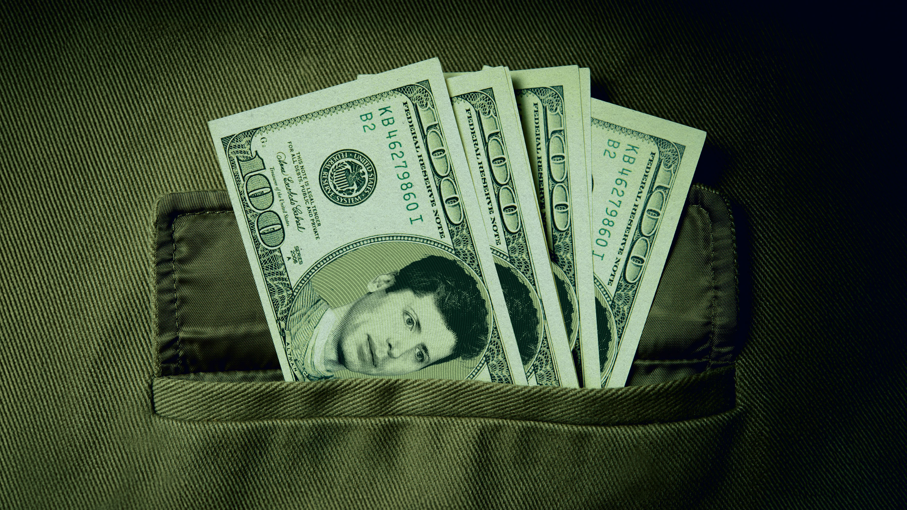Sam Altman's face on 100 dollar bills in a pocket